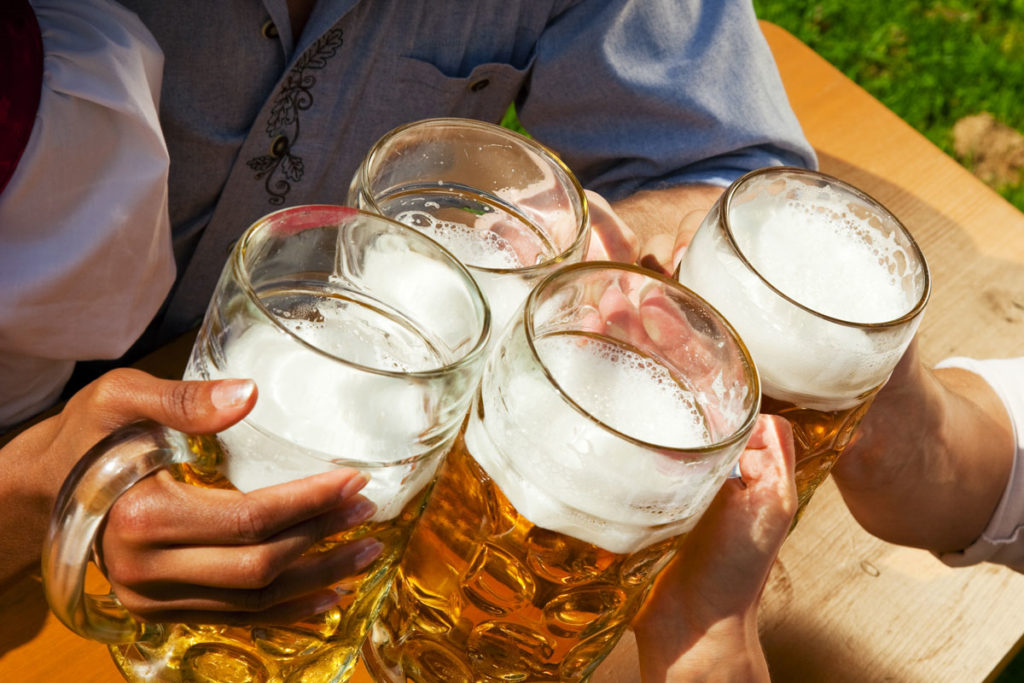 Steins of Bavarian beer raised in a toast