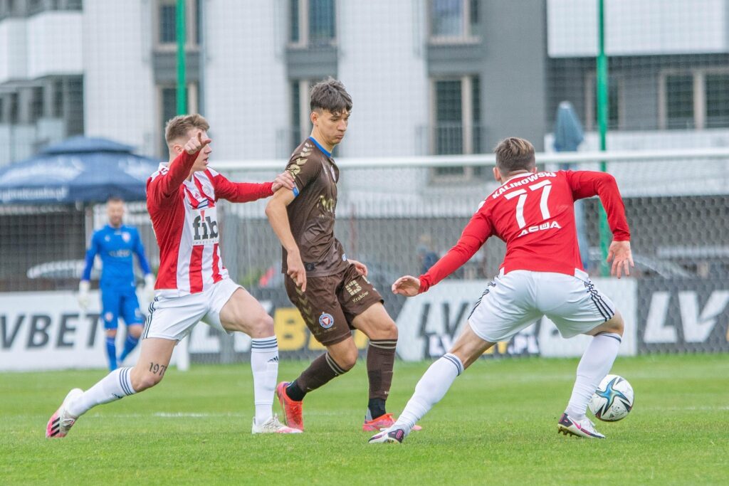 Footballers contesting the ball during a match